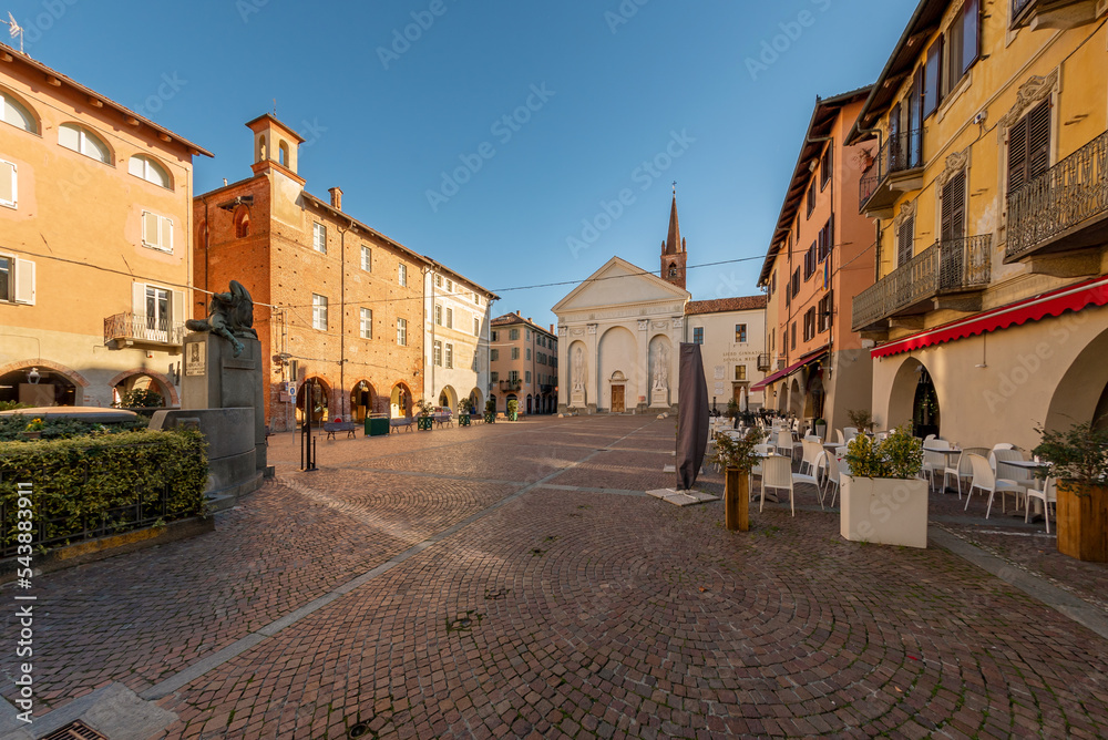 Carmagnola, Turin, Italy - November 05, 2022: Sant Agostino square with Church of Sant'Agostino (15th century) in Gothic style and ancient medieval buildings with arcades