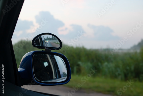 Side mirror of the car at sunset nature