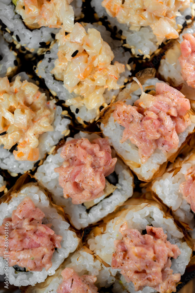 Japanese national dish of sushi, rolls with red fish and salmon chips Japanese national dish of sushi, rolls with red fish and salmon chips