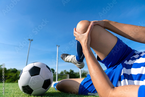 Fototapeta Naklejka Na Ścianę i Meble -  football soccer player accident knee injury sport treatment on champion league final match competition with ball on grass in stadium