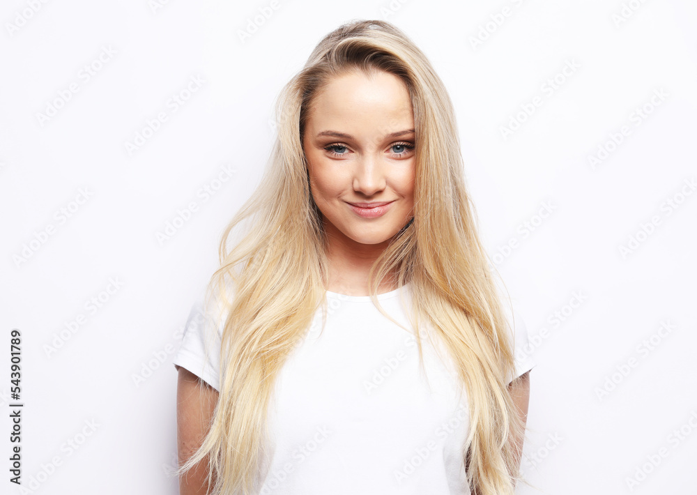 Attractive excited young blond woman wearing casual clothing standing isolated over white background Attractive excited young blond woman wearing casual clothing standing isolated over white background