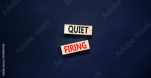 Quiet firing symbol. Concept words Quiet firing on wooden blocks. Beautiful black table black background. Business and quiet firing concept. Copy space.