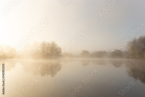 Foggy early morning on a lake.