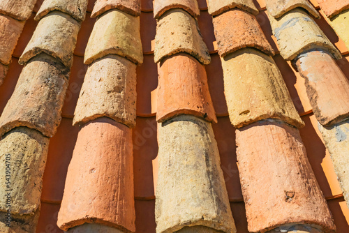 Abstract background featuring detail of old house roof with rows of ochre, brown and yellow roof tiles in Dubrovnik, Croatia. Mediterranean urban background. 