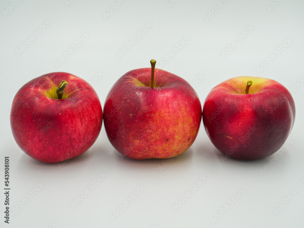 Three red apples arranged in a line Three red apples arranged in a line