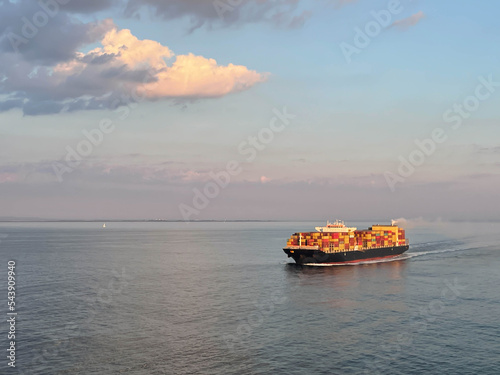 Ultra large container ship sailing during sunset time