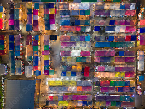 Aerial top view of Night Market people walking street, Colorful tents in the train of Ratchada at Bangkok city, Thailand. Rerail shops