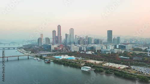 Seoul: Aerial view of capital city of South Korea, skyline of Yeoui-dong with modern buildings (skyscrapers) at sunset, tree foliage in autumn colors - landscape panorama of Eastern Asia from above photo