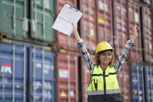 Caucasian engineer worman work in container port terminal. Female Industrial Engineer in Hard Hat, High-Visibility Vest Working. Inspector or Safety Supervisor in Container Terminal. logistics. photo