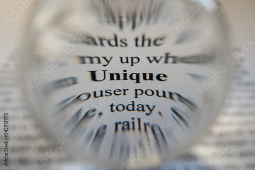 The word Unique has been focussed in on and singled out using selective focus and Bokeh to blur out the surrounding words drawing the viewers eye to the one specific word that is the subject  photo