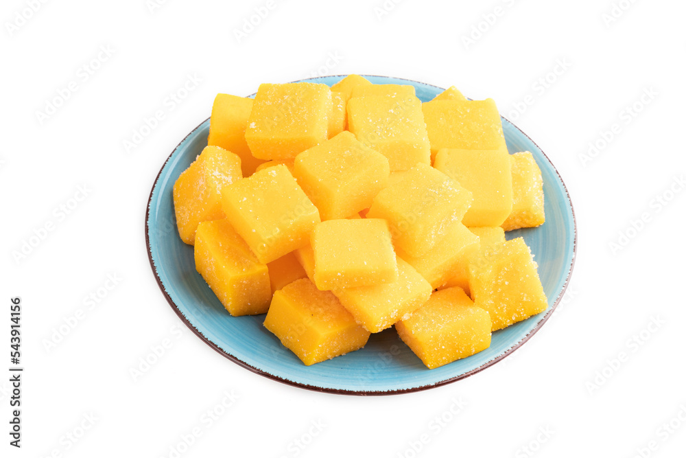Dried mango cubes on blue plate isolated on white, side view. Dried mango cubes on blue plate isolated on white, side view.