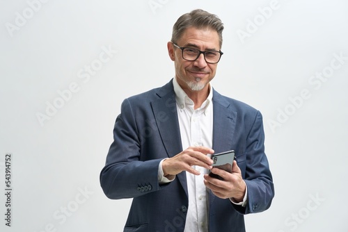 Business portrait of confident businessman working with phone. Entrepreneur in jacket and tie, smiling, Mid adult, mature age man standing, isolated on white background.
