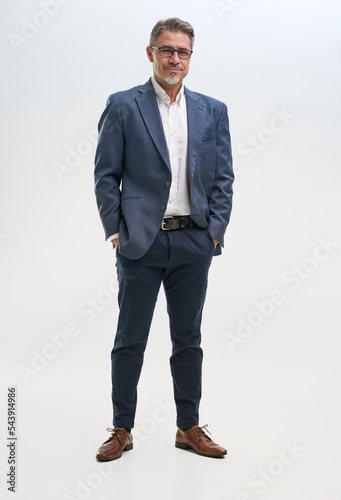 Full length portrait of confident businessman. Entrepreneur in business casual, smiling, Happy mid adult, mature age man standing, smiling, isolated on white background.