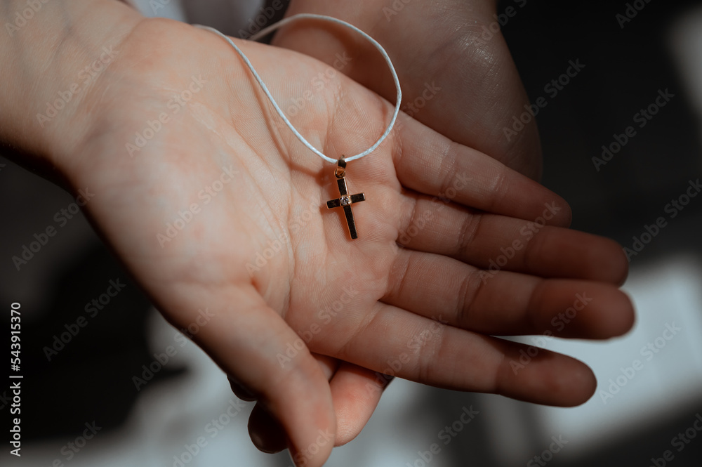little baby hand holding a cross for baptism little baby hand holding a cross for baptism
