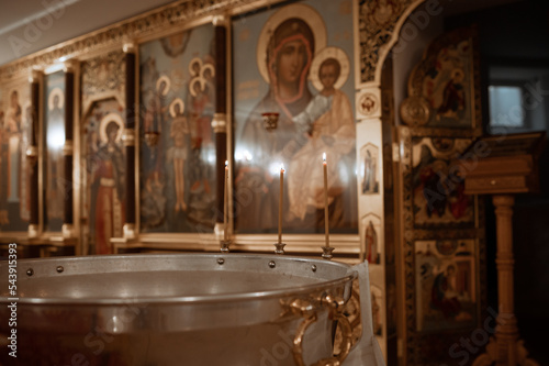Fotobehang baptism font with water with burning candles in an Orthodox church