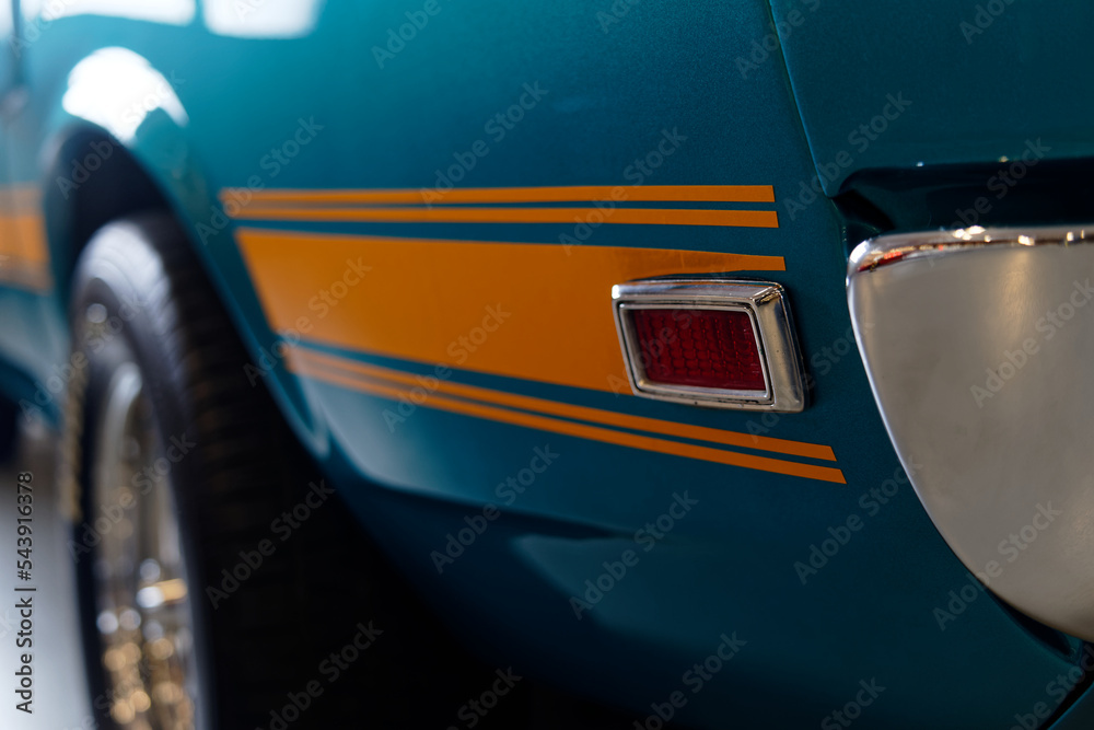 A close up of a powerful blue American muscle car. Vintage car wallpaper. Classic car background.
