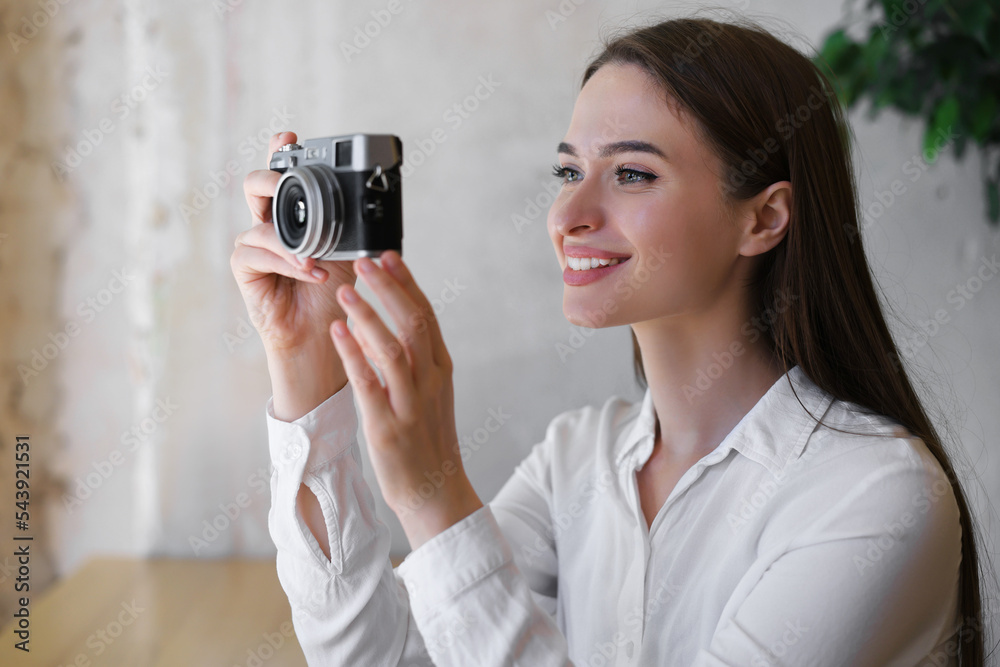 Young woman taking picture at cafe. Creative hobby Young woman taking picture at cafe. Creative hobby