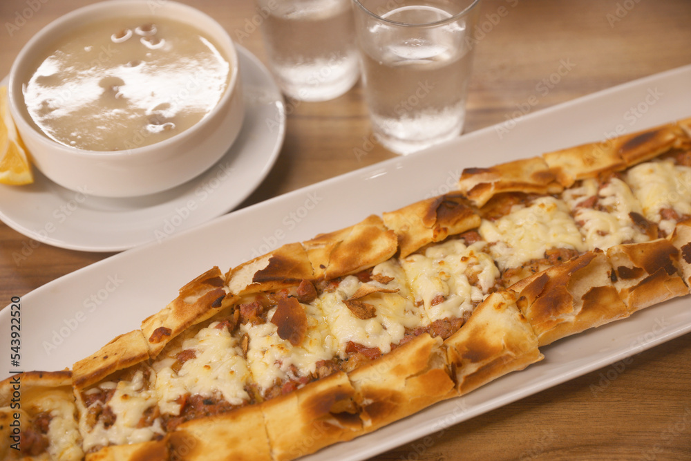 Delicious pide on wooden table, closeup. Traditional Turkish street food Delicious pide on wooden table, closeup. Traditional Turkish street food