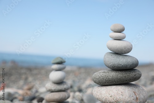 Stack of stones on beach against blurred background  closeup. Space for text