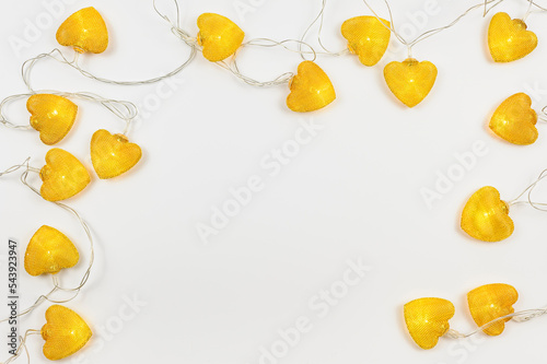 Bright orange lanterns in the shape of hearts. Top view, a holiday card with a white background. Space for text. 