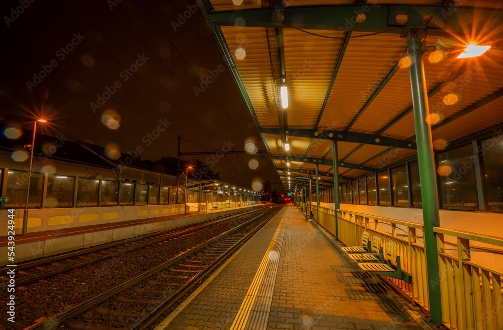 Railway track and train light in night in Prague Podbaba station