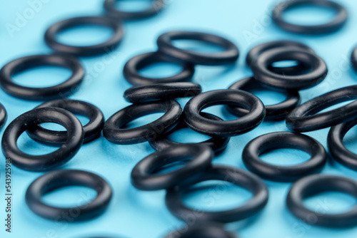 Black sealing rubber gaskets on colored blue background photo