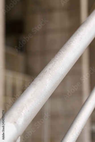 Galvanized steel street handrail on concrete building wall background