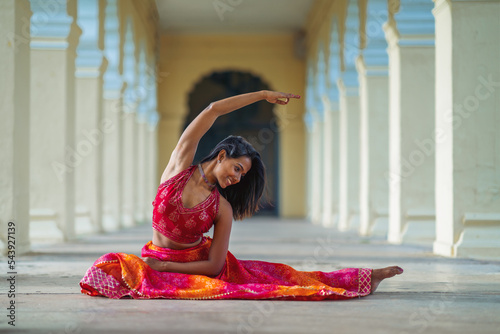 Yogini dancing and practicing yoga near a palace in Mysore, India. Mindful yoga practice. Improvisation. Contemporary dance. photo