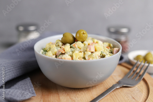 Ensaladilla Rusa in gray bowl. Traditional Spanish food is tapas. Selective focus.