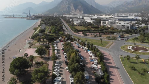 A camping place on the coast. A bird's-eye view from the unmanned aerial vehicle of the caravan motorhome camping. Surrounded by nature on the shores of the Mediterranean Sea. High quality 4k frames photo