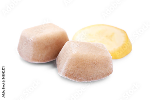 Frozen banana puree cubes and fruit on white background