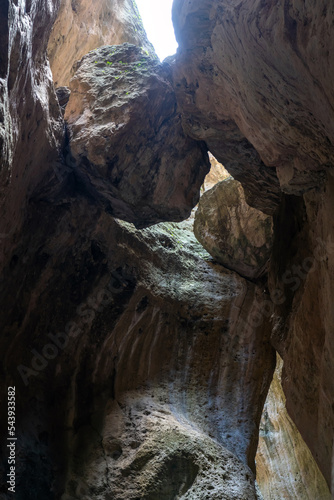 Huge rocks stuck in a crevice in the mountains. View of Karadakh gorge in mountains of Dagestan, Russia. Beautiful curved canyon in sunny weather. © sommersby