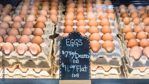 Eggs for sale on display for local business stall at farmer's market. Fresh brown chicken eggs organic produce background