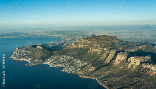 aerial landscape view with the famous Table Mountain National Park, the Lion's Head, the twelve apostle and Camps Bay with white sand beach and blue ocean - aerial panoramic view 