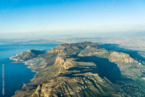 aerial landscape view with the famous Table Mountain National Park, the Lion's Head, the twelve apostle and Camps Bay with white sand beach and blue ocean - aerial panoramic view 