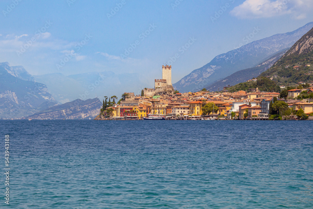 View from lakeside walkway to famous mediterrean town Malcesine, Lago di Garda (Garda lake), Italy