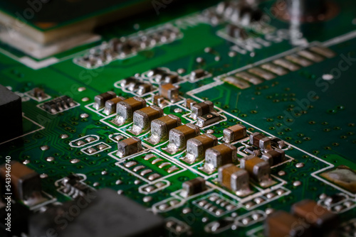 Close-up to green printed circuit board with electronic components.	 photo