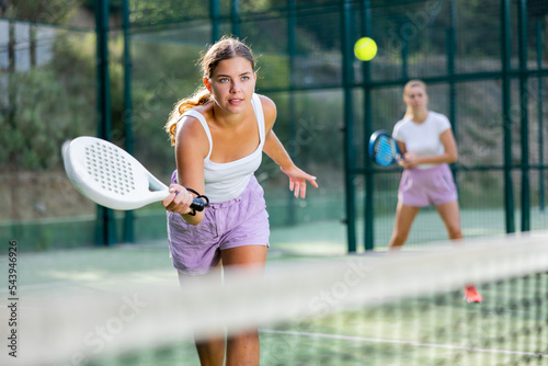 Padel game - woman with partners plays on the tennis court © JackF