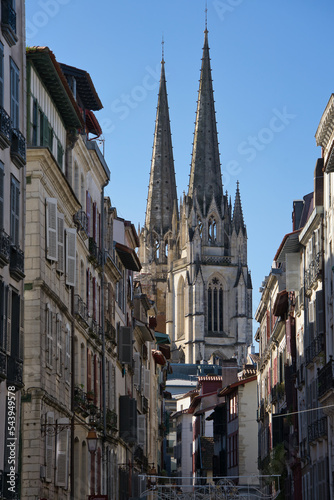 Views between buildings of the Sainte-Marie Cathedral of Bayonne during a sunny day.