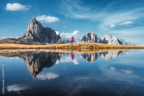 Woman and mountains reflect...