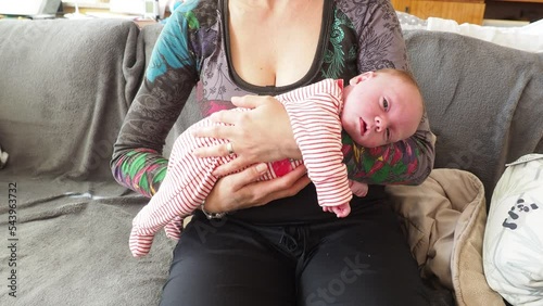 Mother holding newborn baby inher arms. Resting in lap. photo