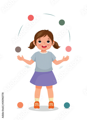 Cute little girl practicing juggling balls