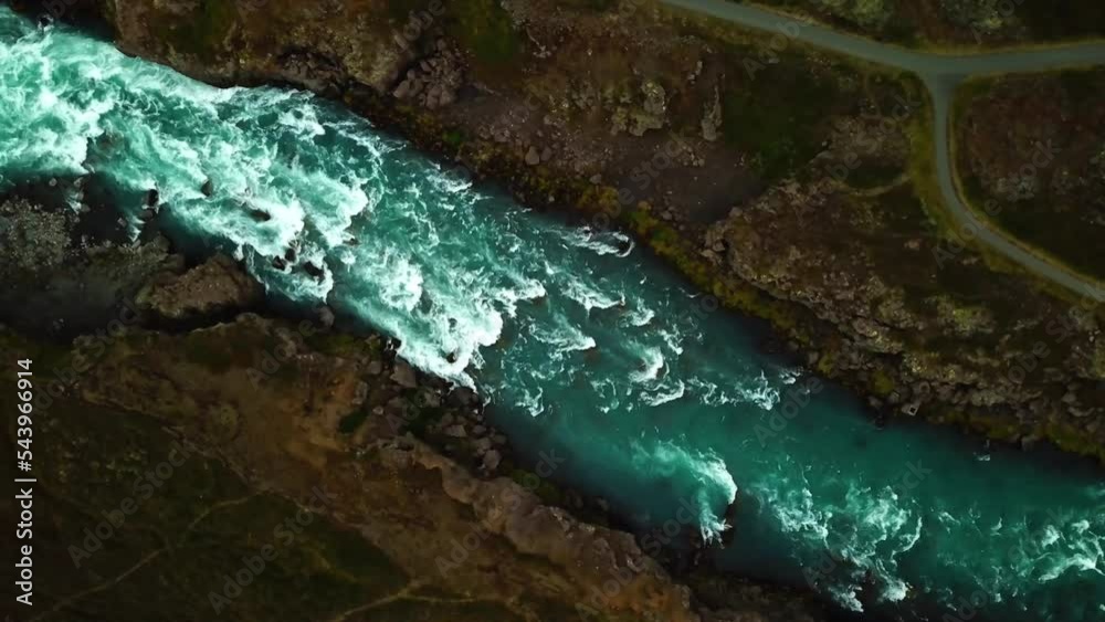 Aerial top view of river water flowing down from Godafoss waterfall, Iceland, on a cloudy day Aerial top view of river water flowing down from Godafoss waterfall, Iceland, on a cloudy day