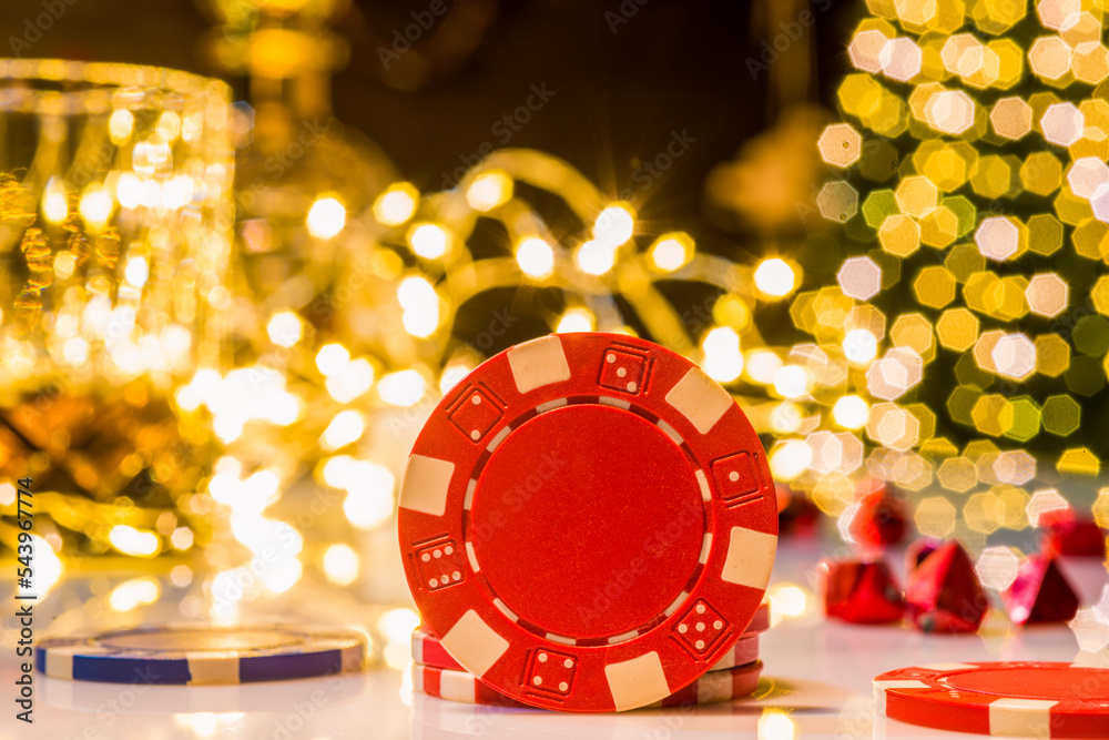 poker chips in a christmas festive atmosphere with glowing christmas lights close-up without people