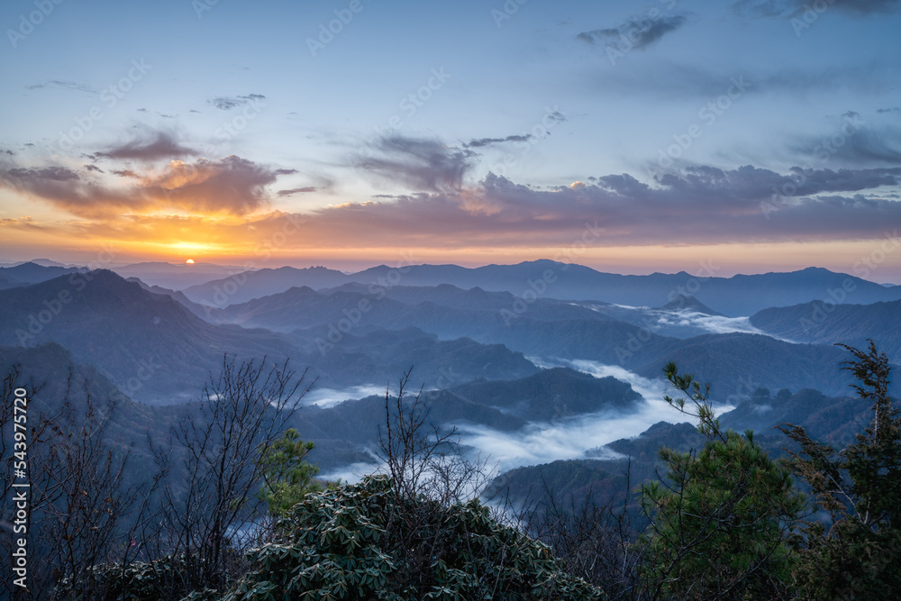 landscape with sunrise and cloud sea over mountains in froggy morning