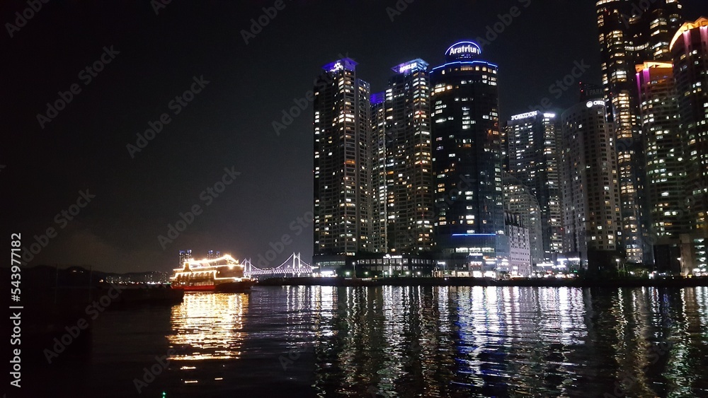 Busan, Korea. Skyscrapers and boat at night. Busan, Korea. Skyscrapers and boat at night.