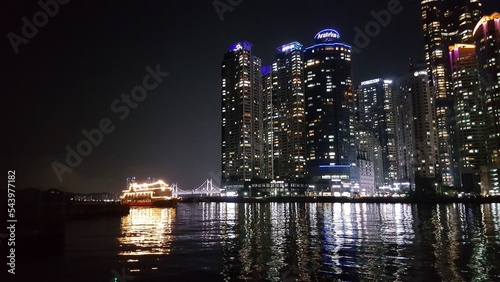 Busan  Korea. Skyscrapers and boat at night.