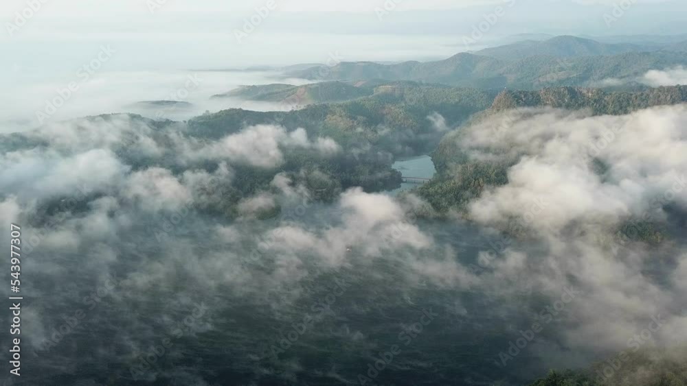 Aerial view of fog moving through Mae Suai reservoir in Chiang Rai province of Thailand at dawn. Aerial view of fog moving through Mae Suai reservoir in Chiang Rai province of Thailand at dawn.