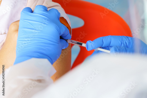 Nurse holding a syringe for the injection giving patient vaccine in hospital. Health care Concept