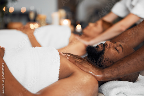 Black man, spa and body massage for couple wellness, relax therapy and skincare treatment. Salon therapist touch muscle, reflexology and healing of sleeping african guy on bed, stress relief and zen